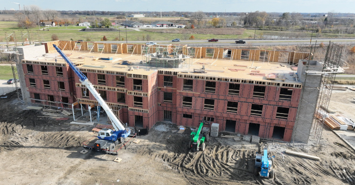 Hotel construction image with fourth floor framing activities.